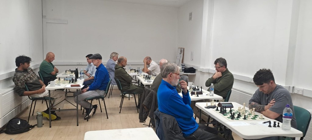 Players from Staines A and Ealing B across six chessboards during their Division Two match in Egham